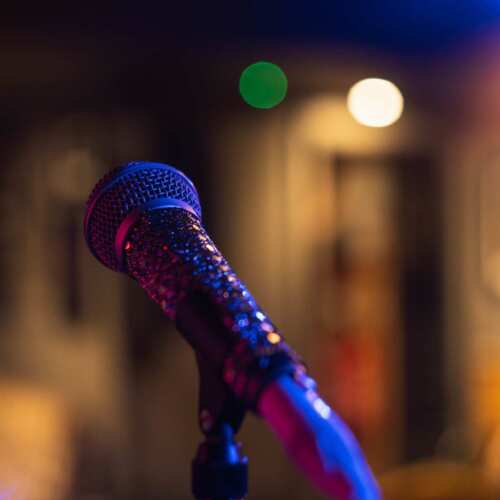 Closeup shot of a microphone on a blurred background with bokeh lights A closeup shot of a microphone on a blurred background with bokeh lights